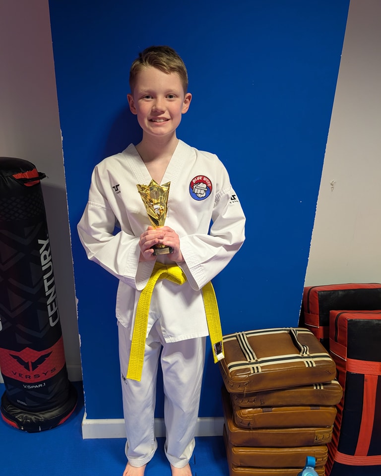 Child earning Taekwondo belt at Washington Taekwondo.”