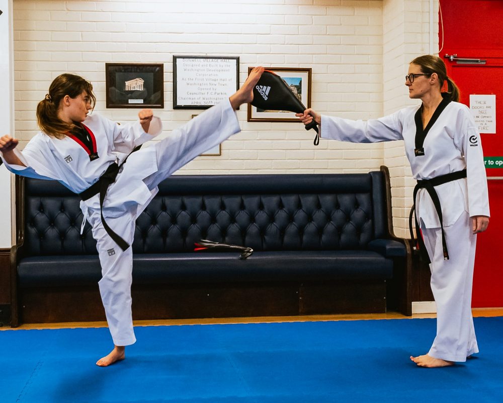 Teenage high kicking at Washington Taekwondo